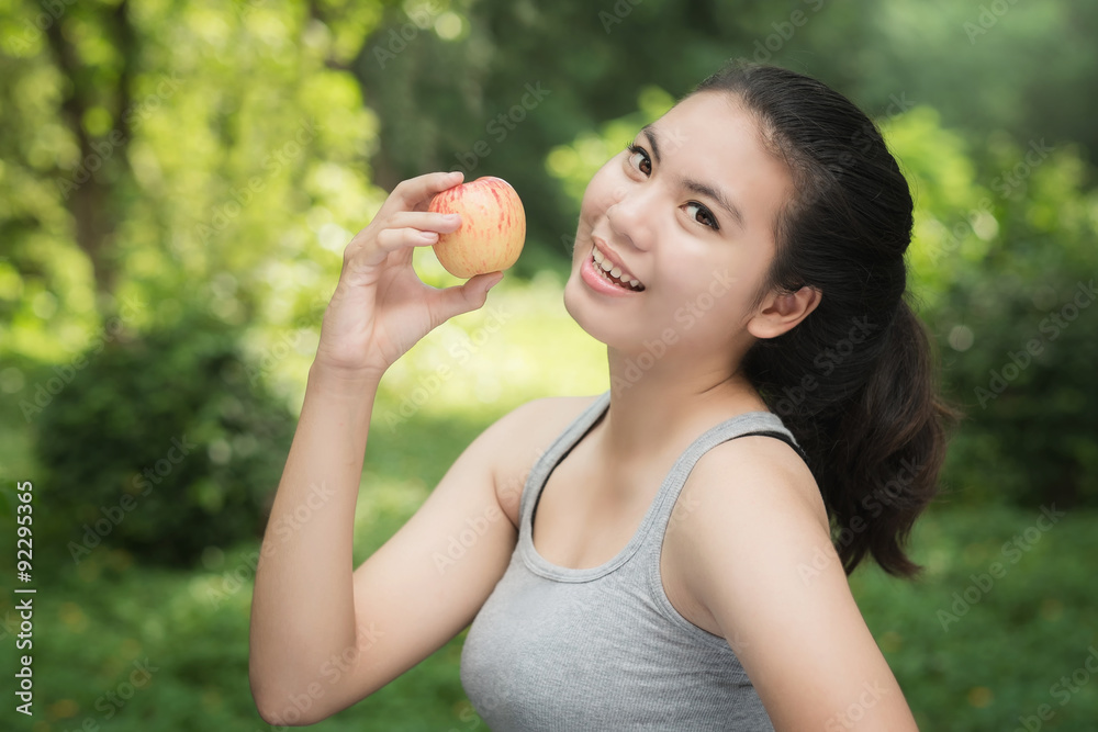 Asian woman eat apple on park for healthy lifestyle Asian woman eat apple on park for healthy lifestyle