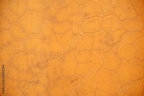 Texture of old wall covered with yellow stucco