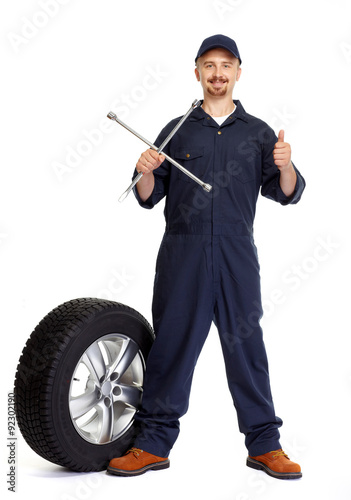 Car mechanic with a tire wrench.