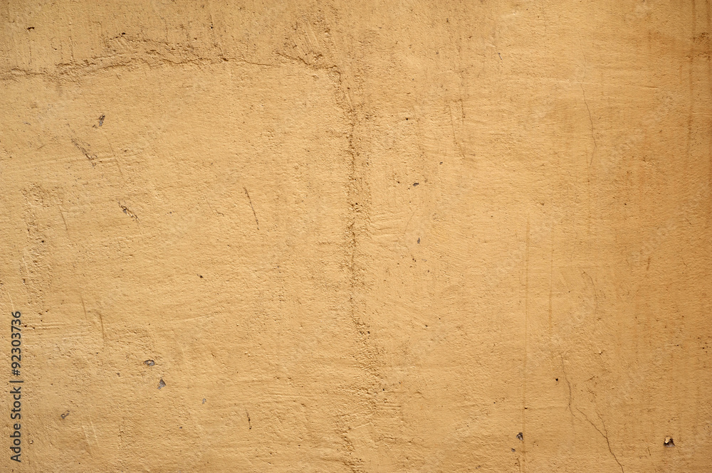 Texture of old wall covered with yellow stucco Texture of old wall covered with yellow stucco