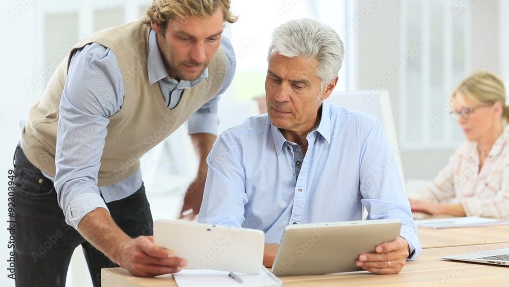 Senior man with tablet attending business class