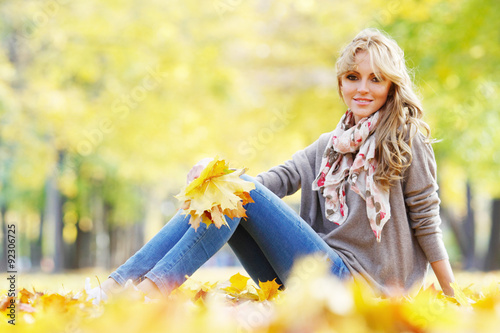 Woman sitting in autumn park