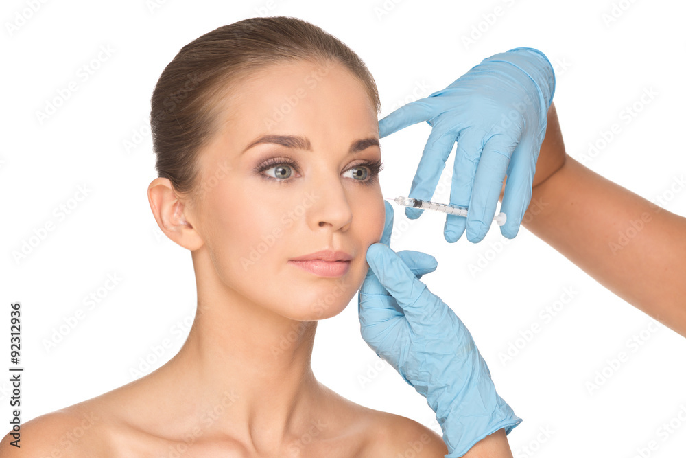 Attractive young woman gets cosmetic injection of botox Attractive young woman gets cosmetic injection of botox
