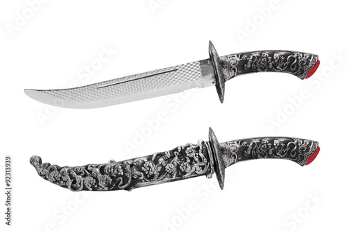 Isolated opened and closed knife with scabbard. Isolated ancient fantasy etched opened and closed knife with scabbard on white background profile view. photo