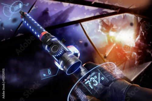 Canvas Print First person view hand in black leather gloves holding a futuristic neon fantasy reloading automatic machinegun with neon indicators and pointers