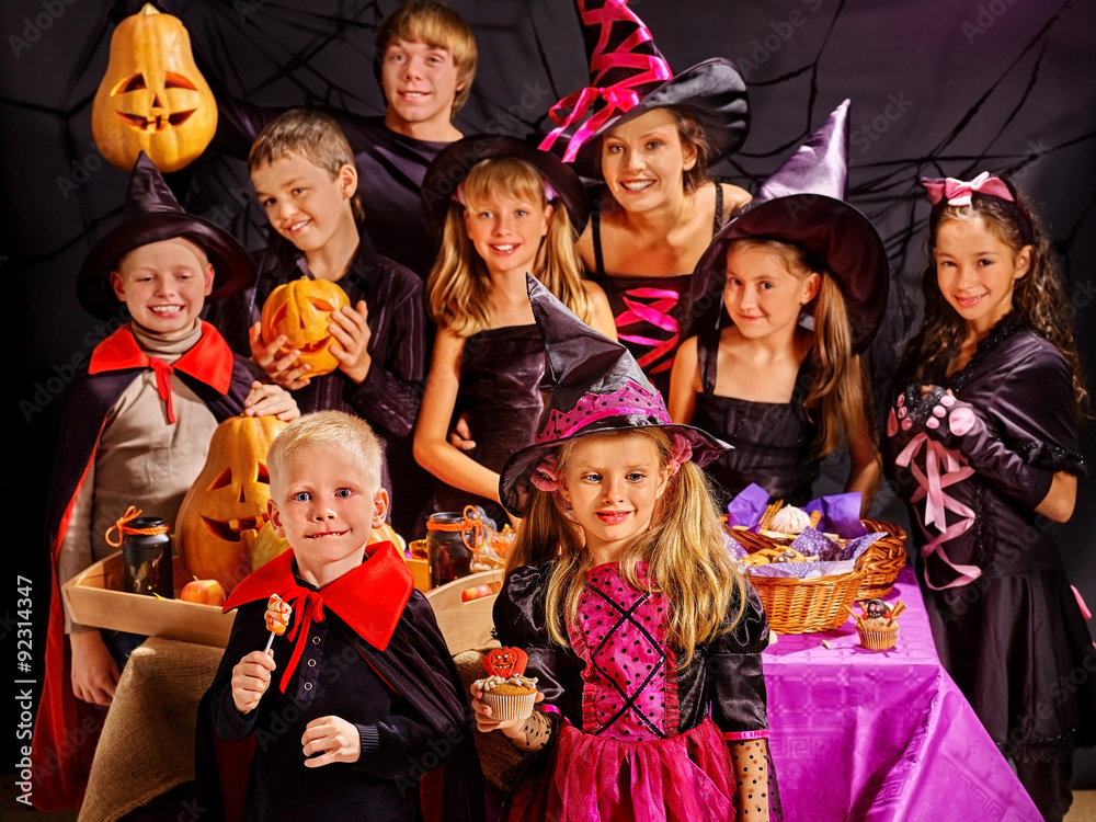 Children on Halloween party making pumpkin Children on Halloween party making pumpkin