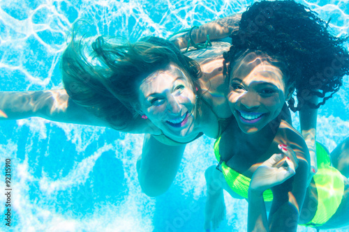 Friends diving underwater in swimming pool © Kzenon