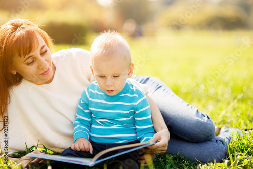 Mother with boy reading book