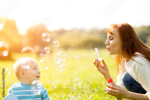 Mother and son making soap bubbles 