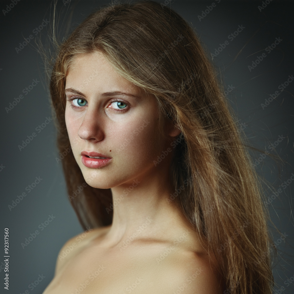 Fototapeta premium Beautiful young woman with long hairs