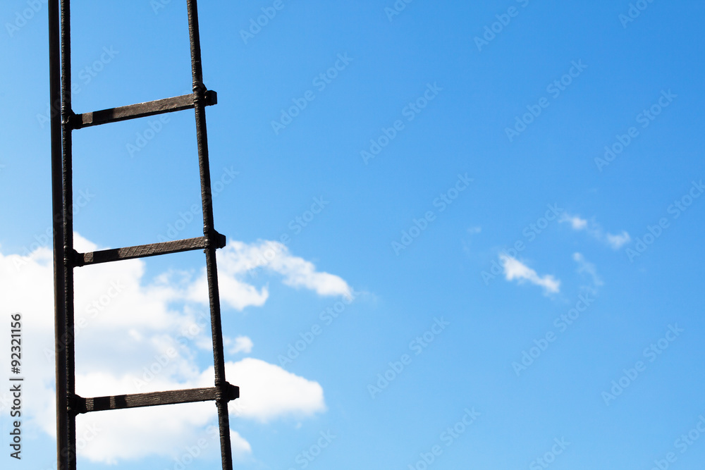 Ladder against a bright blue sky with clouds Ladder against a bright blue sky with clouds