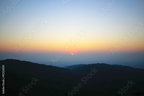 Sunrise and misty hills