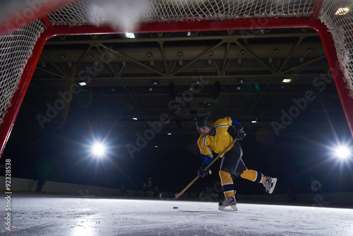 Photography teen ice hockey player in action