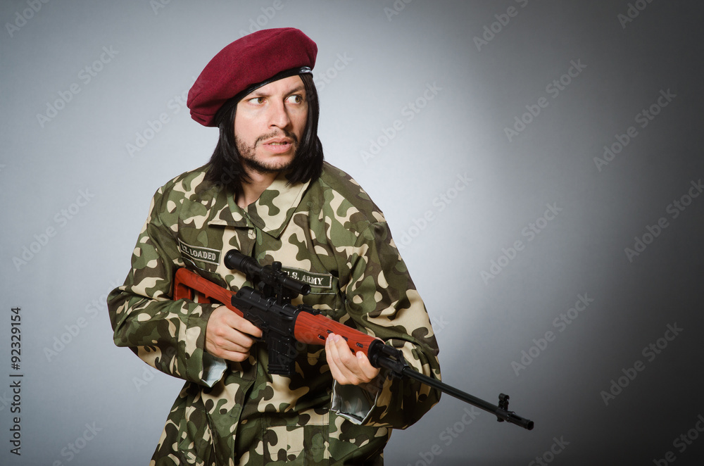 Soldier with handgun against gray Soldier with handgun against gray