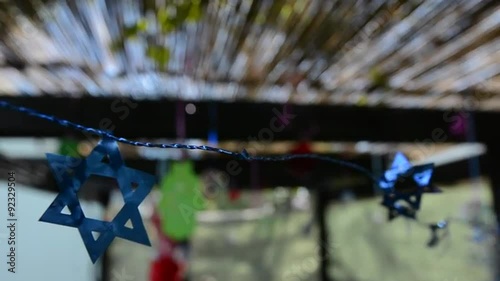 Star of David decorations inside a Jewish family Sukkah for the Jewish festival of Sukkot. A Sukkah is a temporary structure where meals are taken for the week. photo