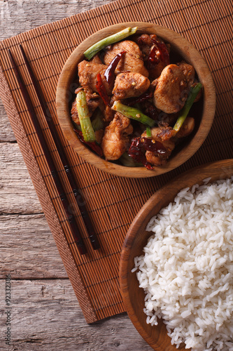 Kung pao chicken fillets in a bowl close up. vertical top view
