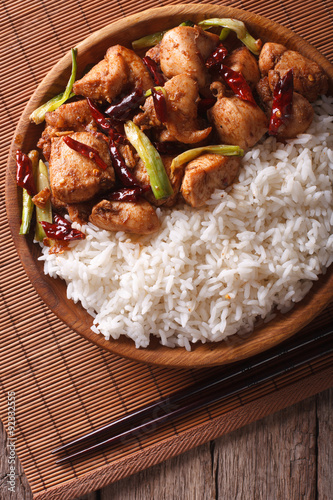 Rice with spicy kung pao chicken close-up. Vertical top view
