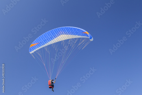 Paraglider isolated on blue sky