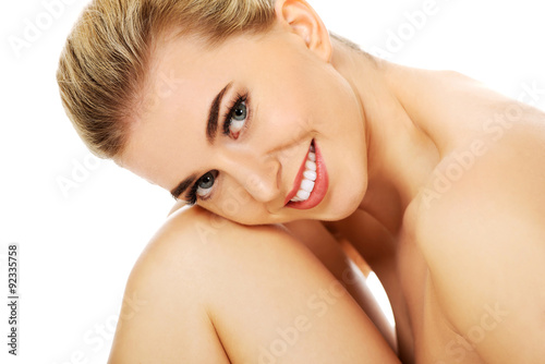 Young smile naked mwoman sitting on the floor photo
