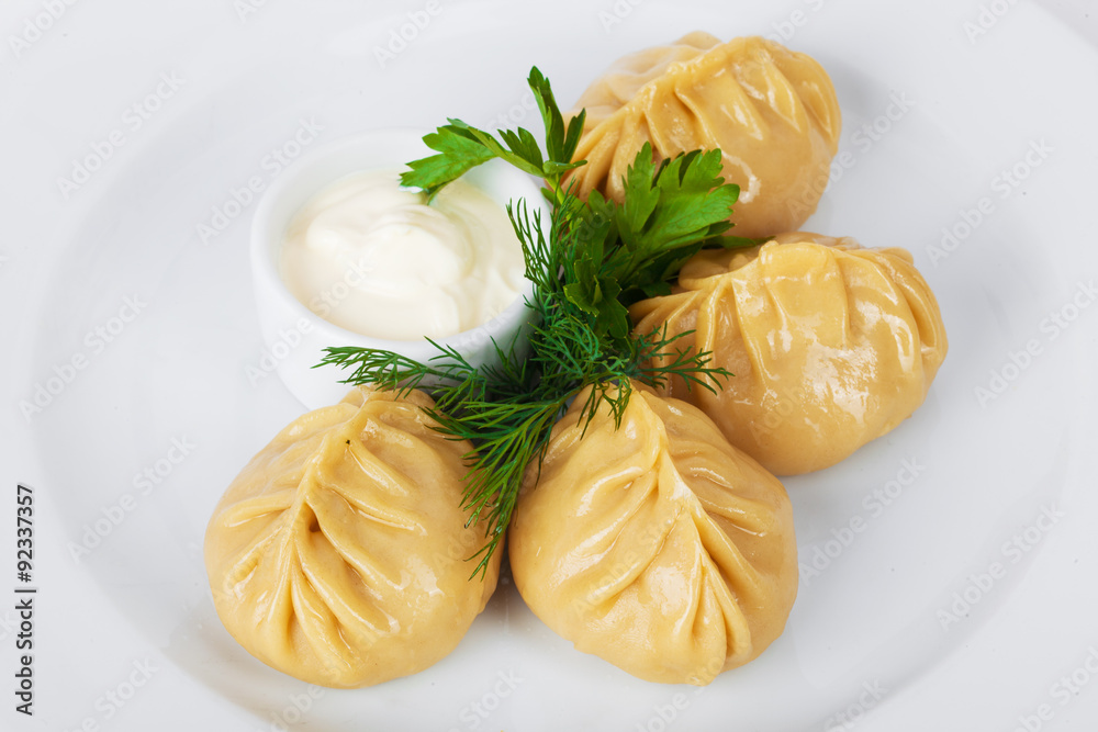 manti parsley with sour cream and dill on a white background manti parsley with sour cream and dill on a white background