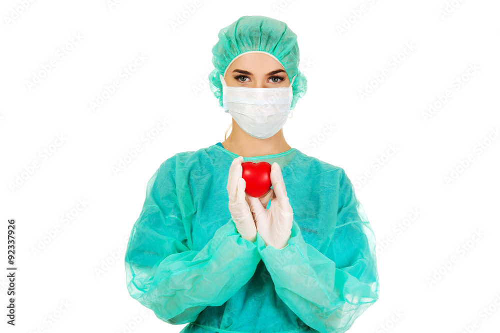 Female surgeon doctor holding heart Female surgeon doctor holding heart