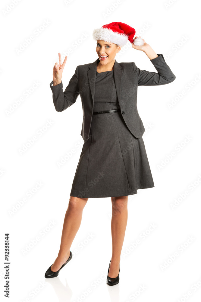 Happy businesswoman wearing christmas hat Happy businesswoman wearing christmas hat