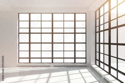 Empty white loft interior with floor-to-ceiling windows