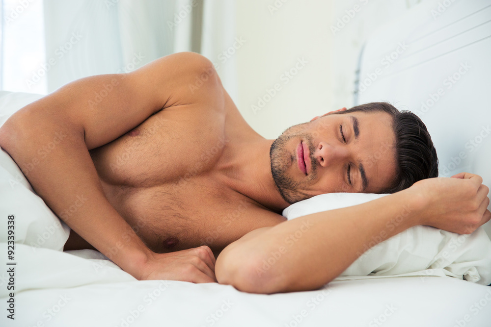 Man sleeping on the bed at home Man sleeping on the bed at home