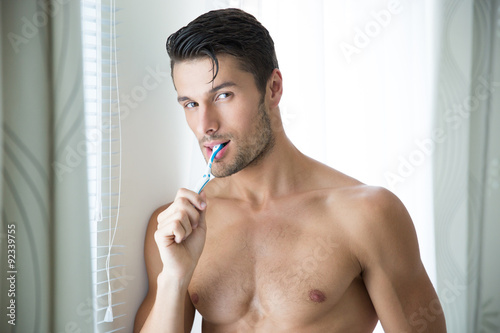 Portrait of a man brushing teeth