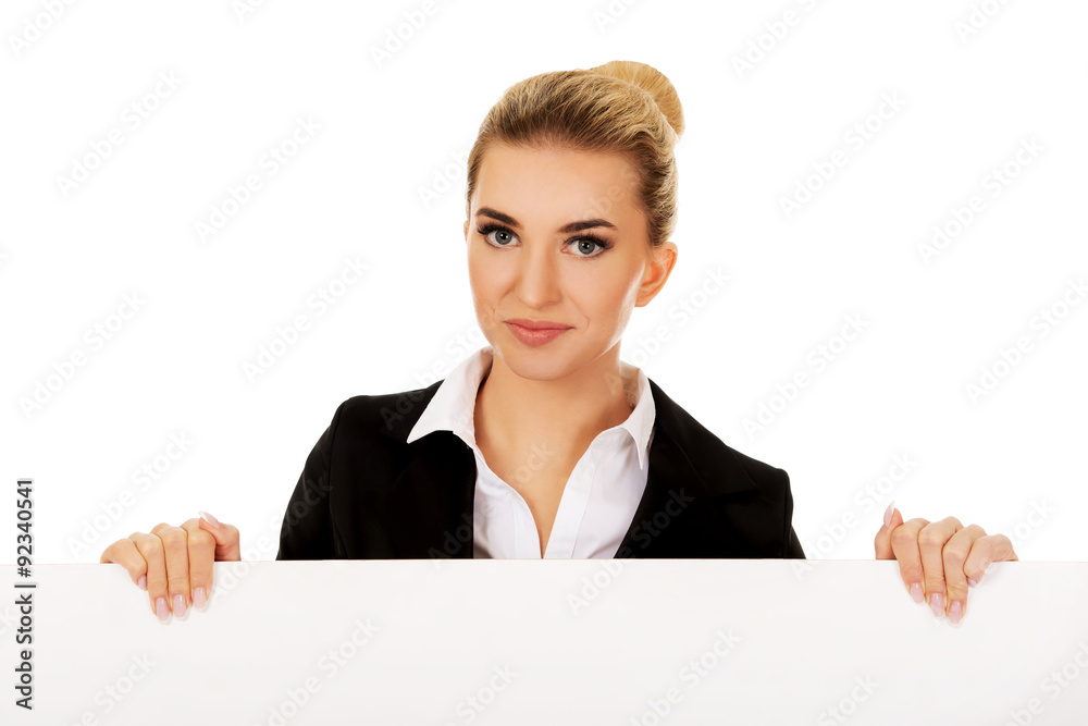 Smiling businesswoman holding empty banner Smiling businesswoman holding empty banner