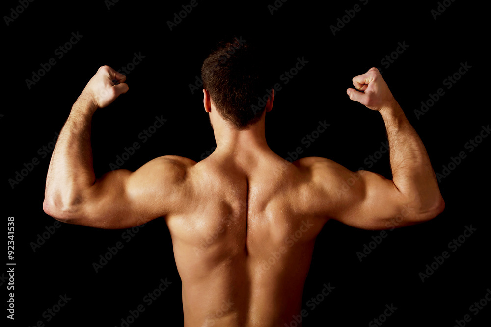 Sexy muscular man showing his muscular back. Sexy muscular man showing his muscular back.