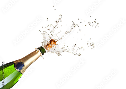 Photo popping champagne bottle on white background