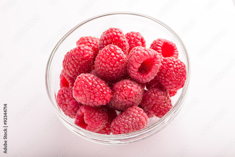 Ripe sweet raspberries in bowl on white Ripe sweet raspberries in bowl on white