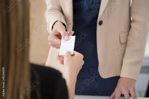 Businesswoman giving her businesscard to her partner