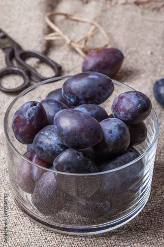 Plums in a glass bowl.