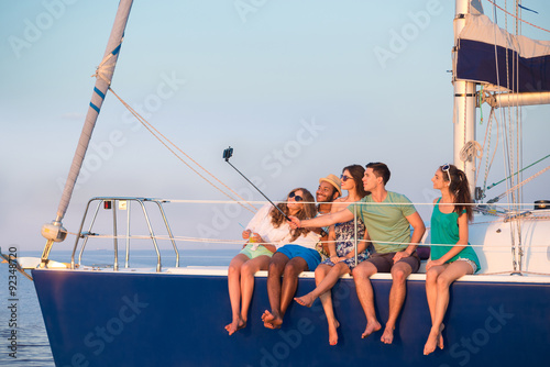 Youth makes selfie on a yacht. © DenisProduction.com