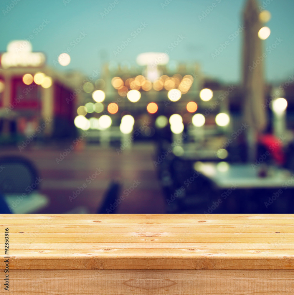 image of wooden table in front of abstract blurred background of resturant lights
image of wooden table in front of abstract blurred background of resturant lights