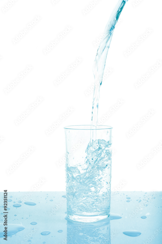 Pouring water from bottle into glass on white background. Pouring water from bottle into glass on white background.