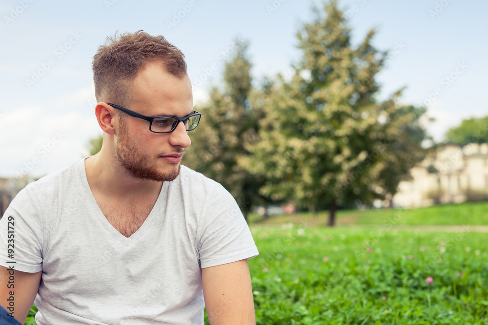 Portrait of bearded young man. Sad caucasian man on sunny summer day. Portrait of bearded young man. Sad caucasian man on sunny summer day.