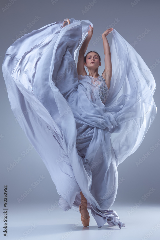 Obraz premium The beautiful ballerina dancing in blue long dress