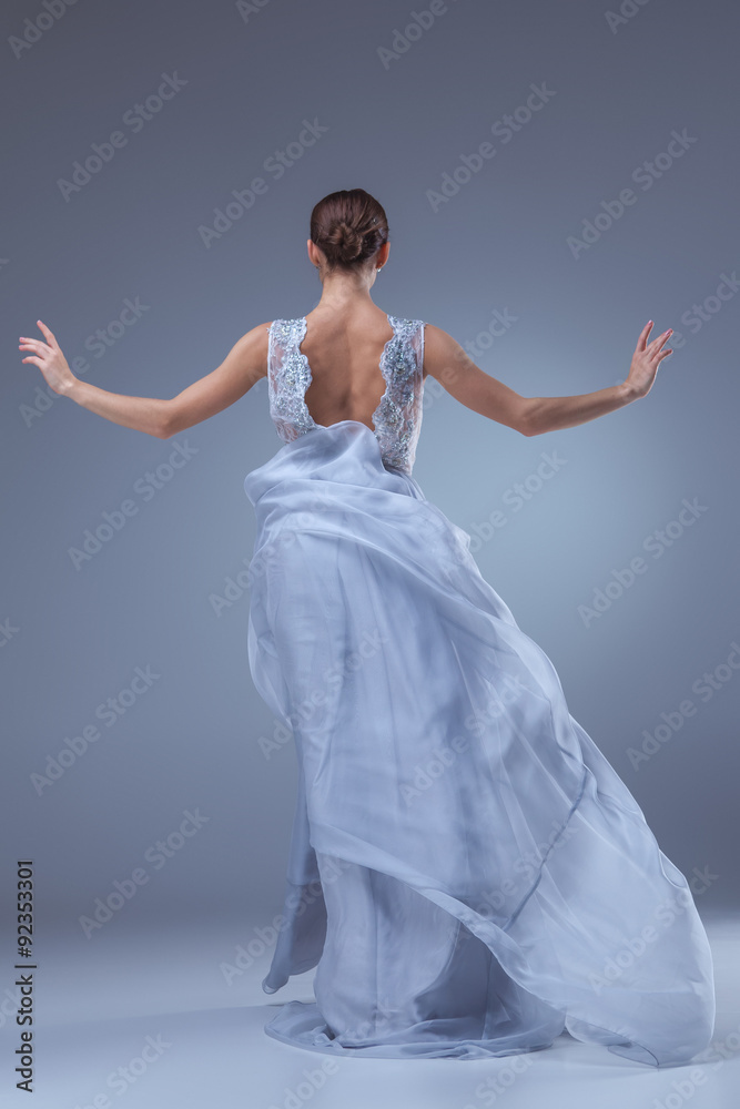 Fototapeta premium The beautiful ballerina dancing in blue long dress 