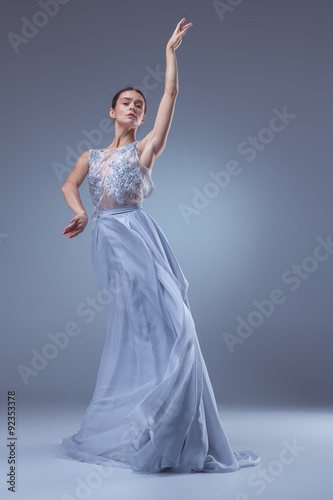 The beautiful ballerina dancing in blue long dress 