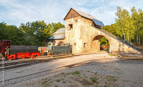 Old unused limestone mine with tracks and train in Bohemia, Czech Republic