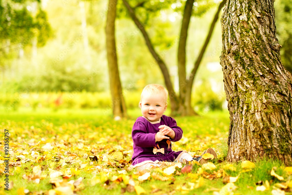 Lttle girl near a tree in the park Lttle girl near a tree in the park