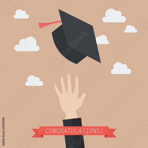 Hand of graduate throwing graduation hats in the air