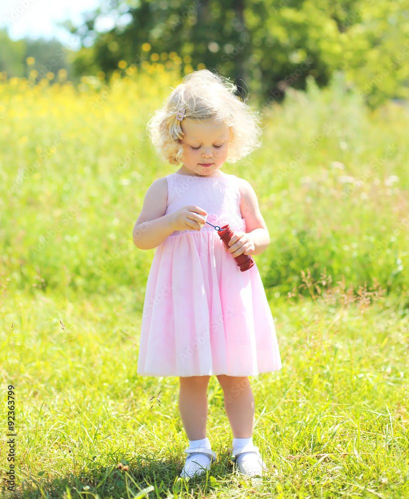 Little girl child with soap bubbles in sunny summer day Little girl child with soap bubbles in sunny summer day