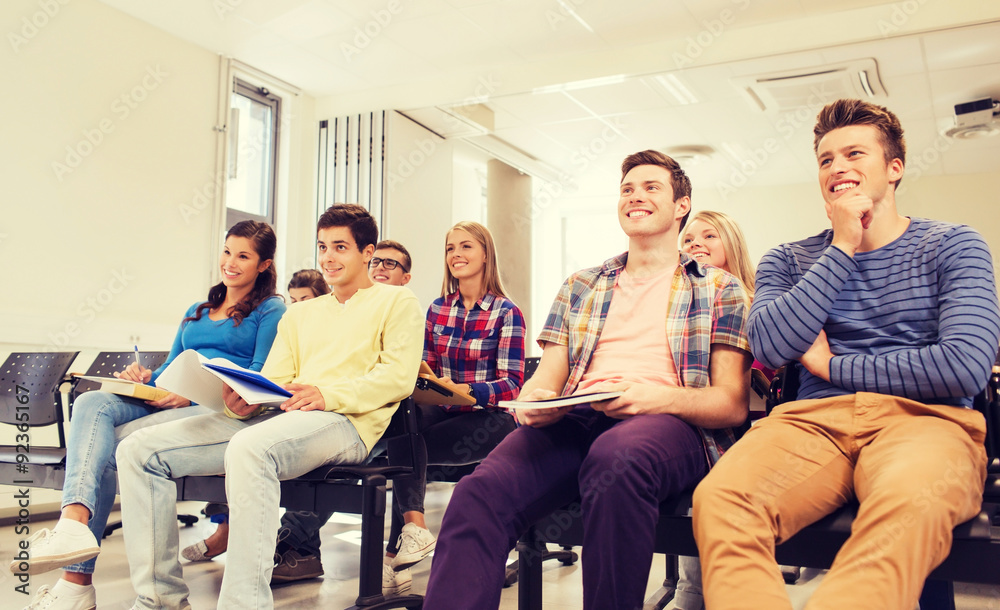 group of smiling students in lecture hall group of smiling students in lecture hall