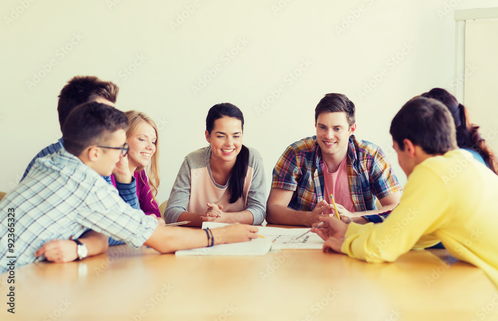 group of smiling students with blueprint group of smiling students with blueprint