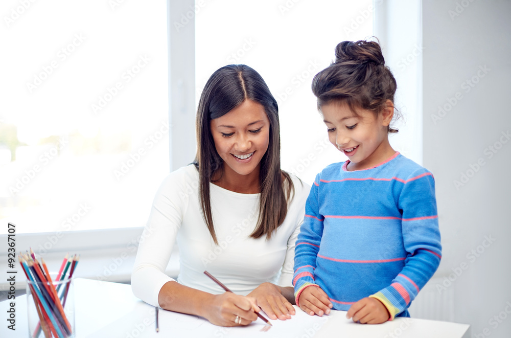 happy mother and daughter drawing with pencils happy mother and daughter drawing with pencils