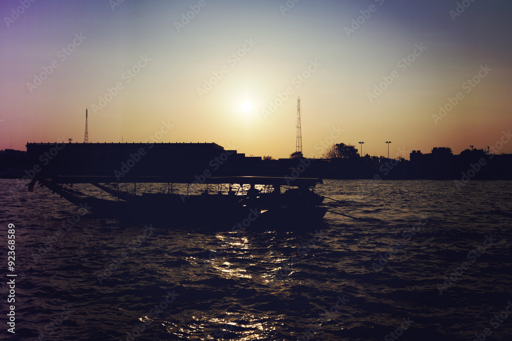 Fototapeta premium River boats crossing the Chao Phraya river in Bangkok, Thailand. with light leak filter.